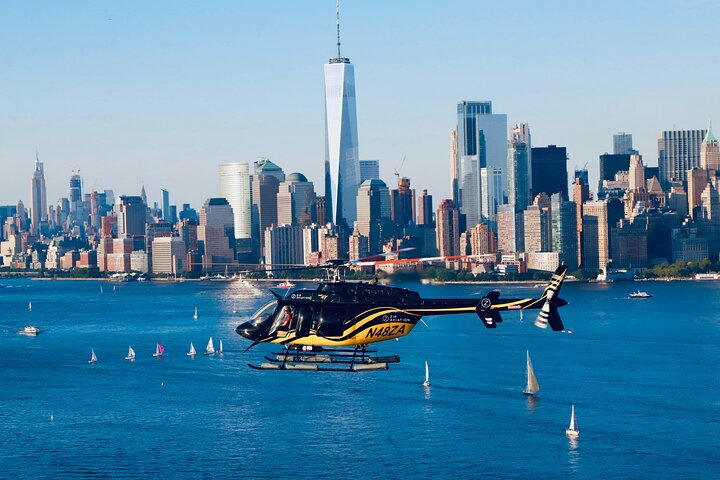 Experience the breathtaking skyline of New York City from above gliding past iconic landmarks like the Statue of Liberty and Empire State Building perfect for unforgettable memories and stunning photos.